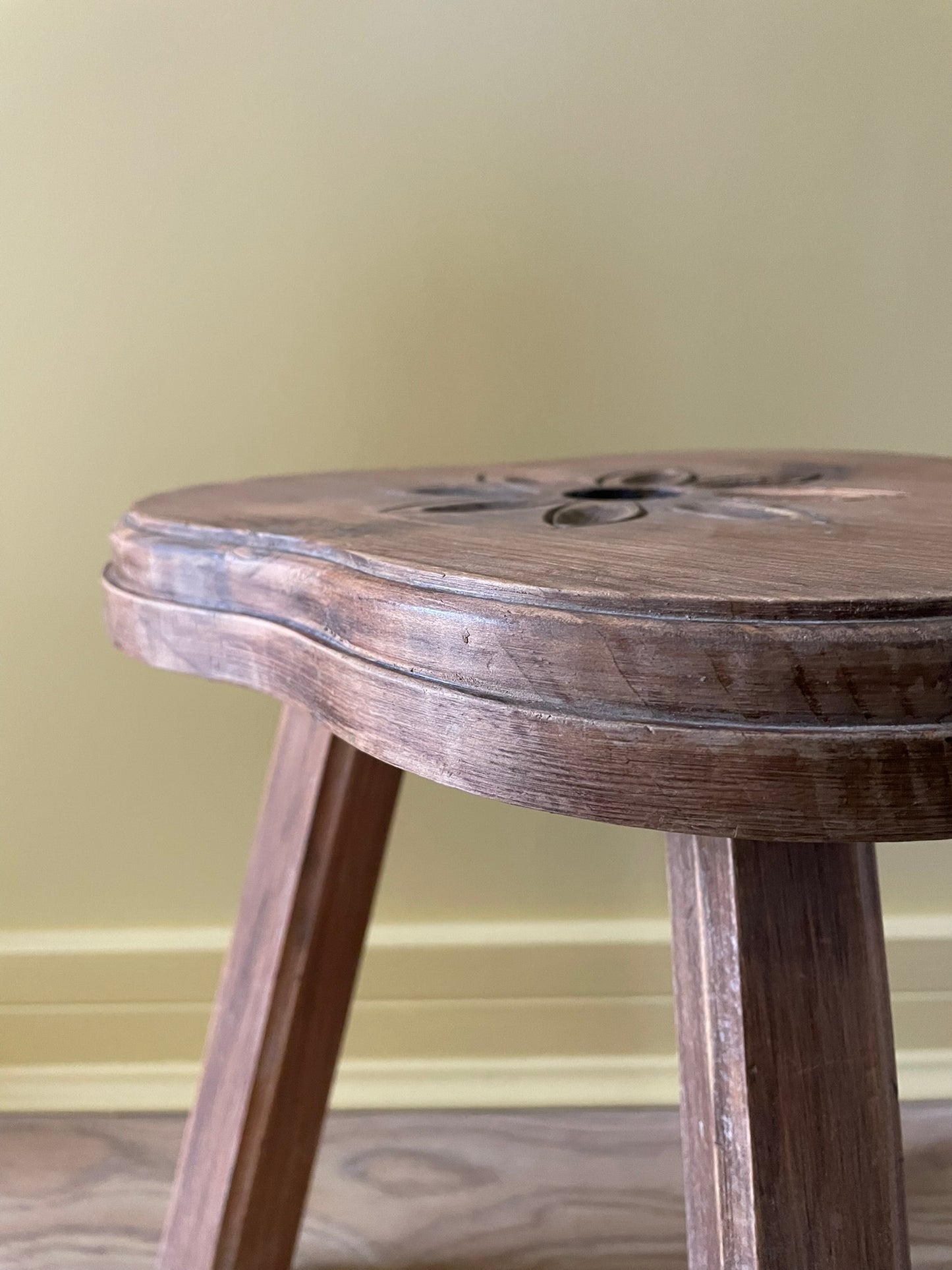 Vintage French wooden milking stool with carved flower