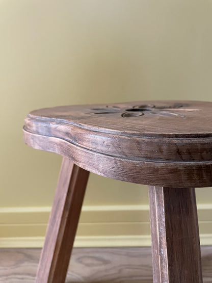 Vintage French wooden milking stool with carved flower