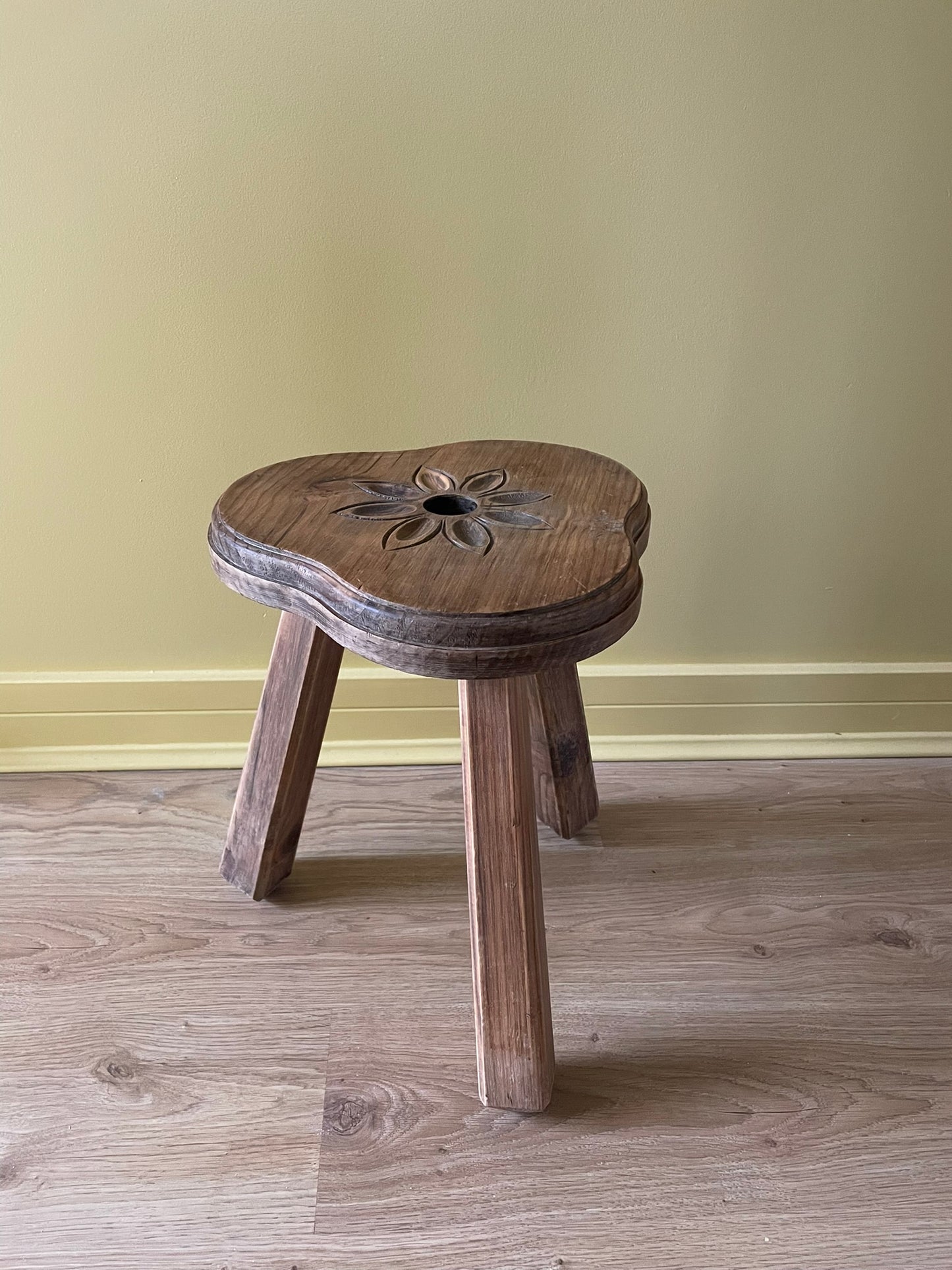 Vintage French wooden milking stool with carved flower