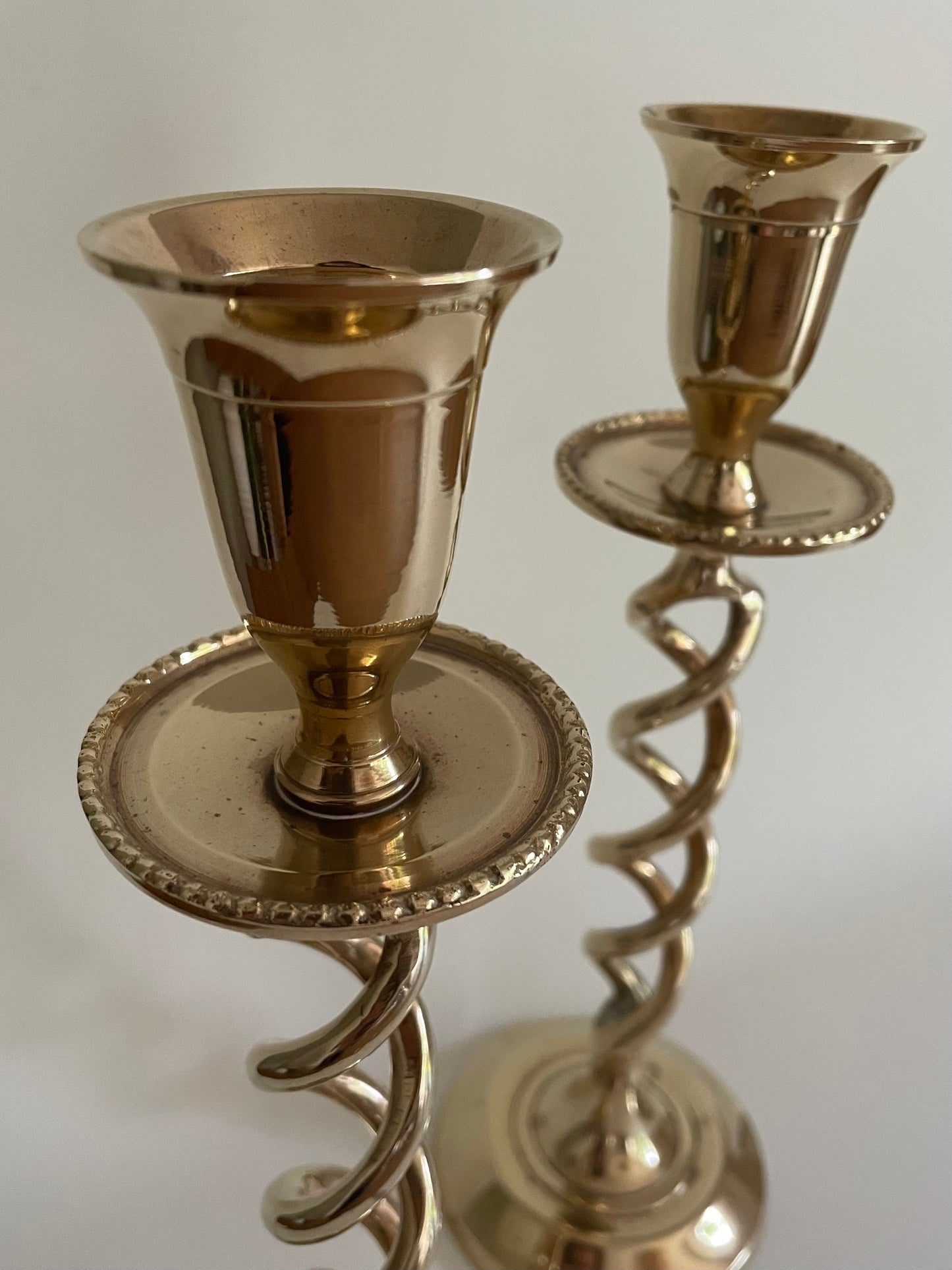 Pair of vintage brass twisted candlestick holders with drip tray for candle wax