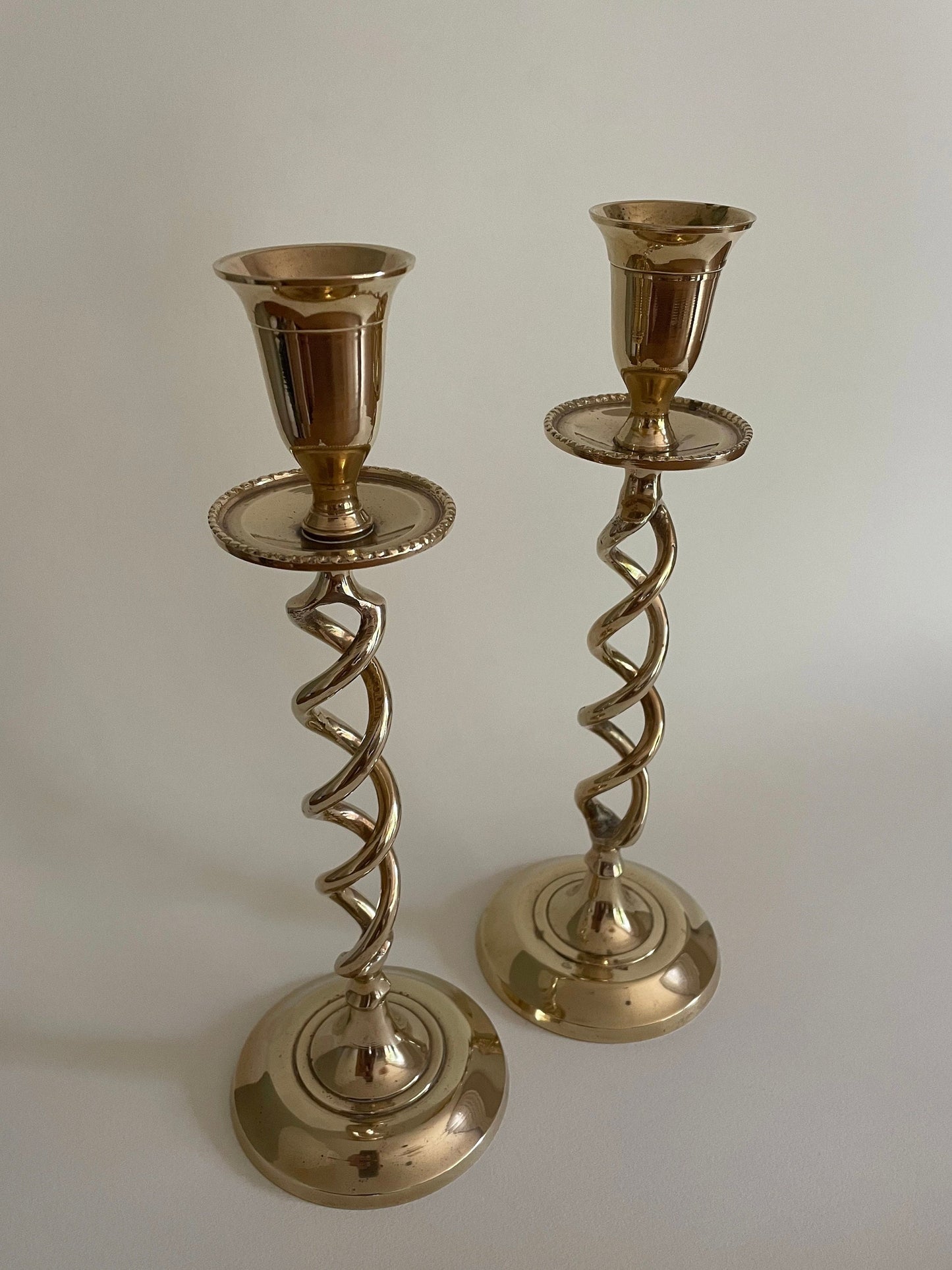 Pair of vintage brass twisted candlestick holders with drip tray for candle wax