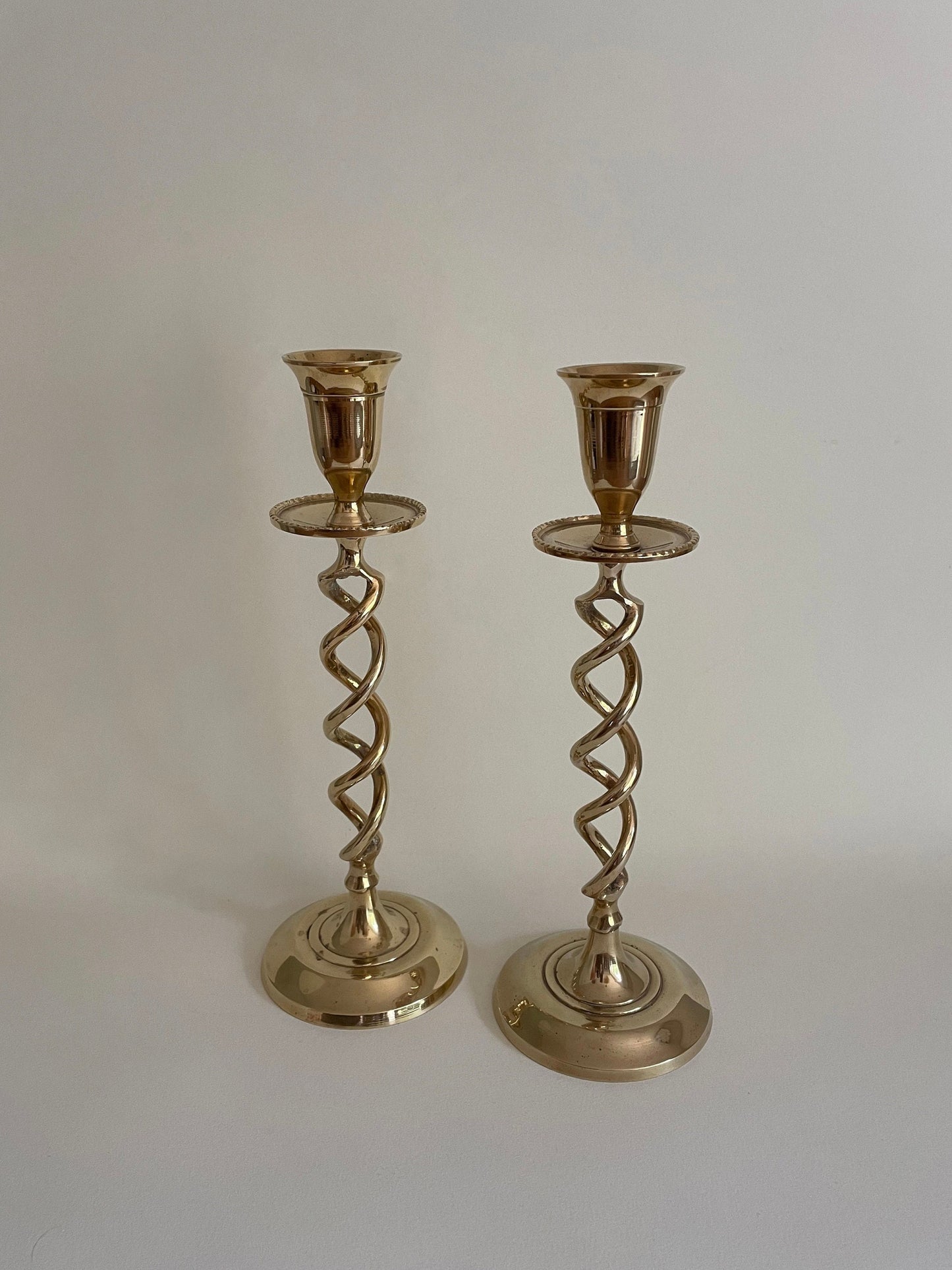 Pair of vintage brass twisted candlestick holders with drip tray for candle wax