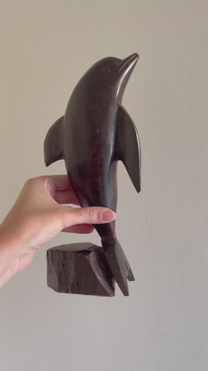 Large wooden dolphin statue